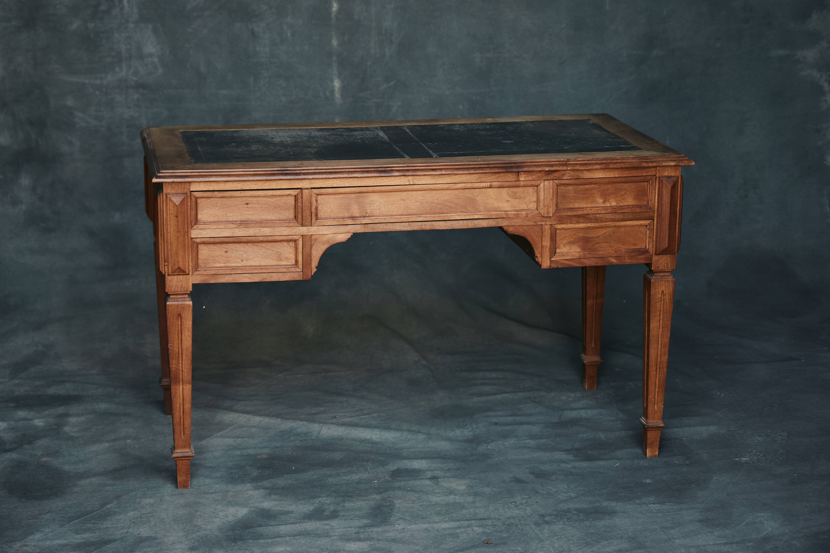 Antique wooden desk with upholstered top and 5 drawers