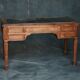 Antique wooden desk with upholstered top and 5 drawers