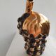 Beautiful black and gold ceramic bottle in the shape of a bunch of grapes.