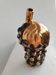 Beautiful black and gold ceramic bottle in the shape of a bunch of grapes.