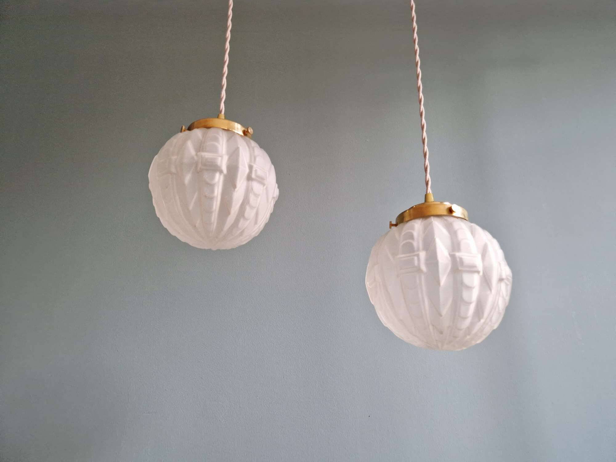 Pair of Art Deco pendant lights in pressed molded satin glass, 1920-30