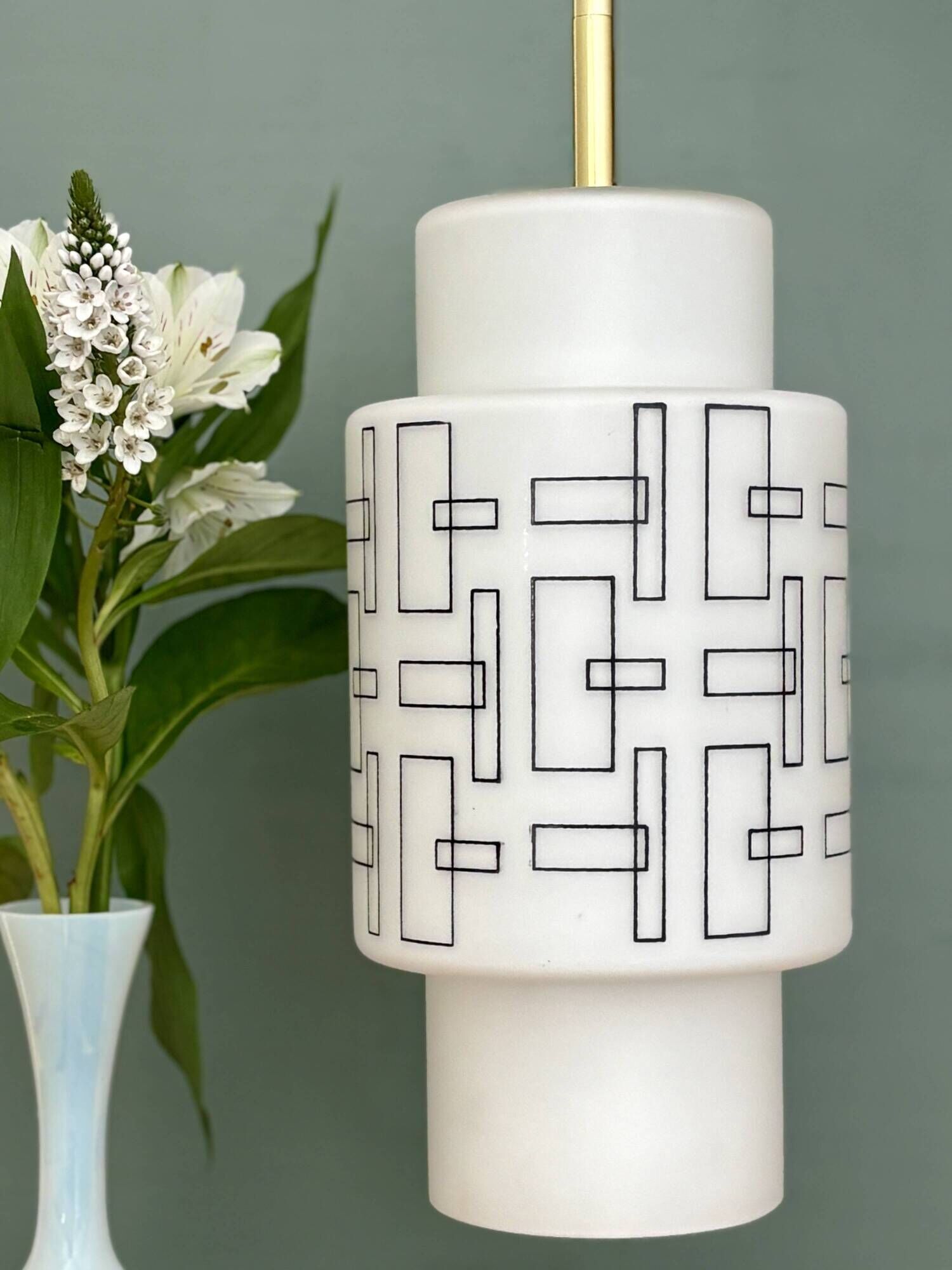Vintage suspension globe in white opaline with black drawings.