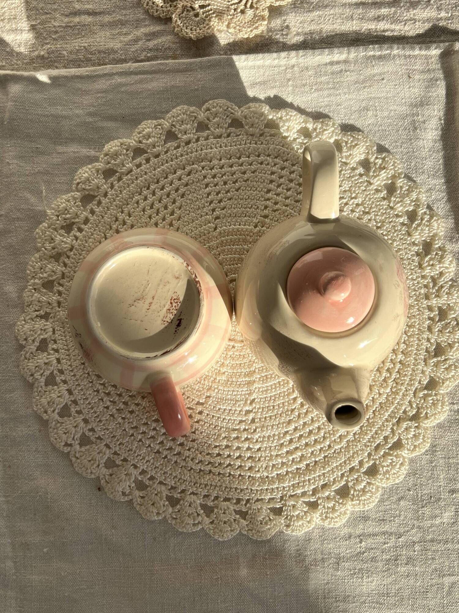 Vintage porcelain teapot and cup set with pink and beige floral and gingham pattern