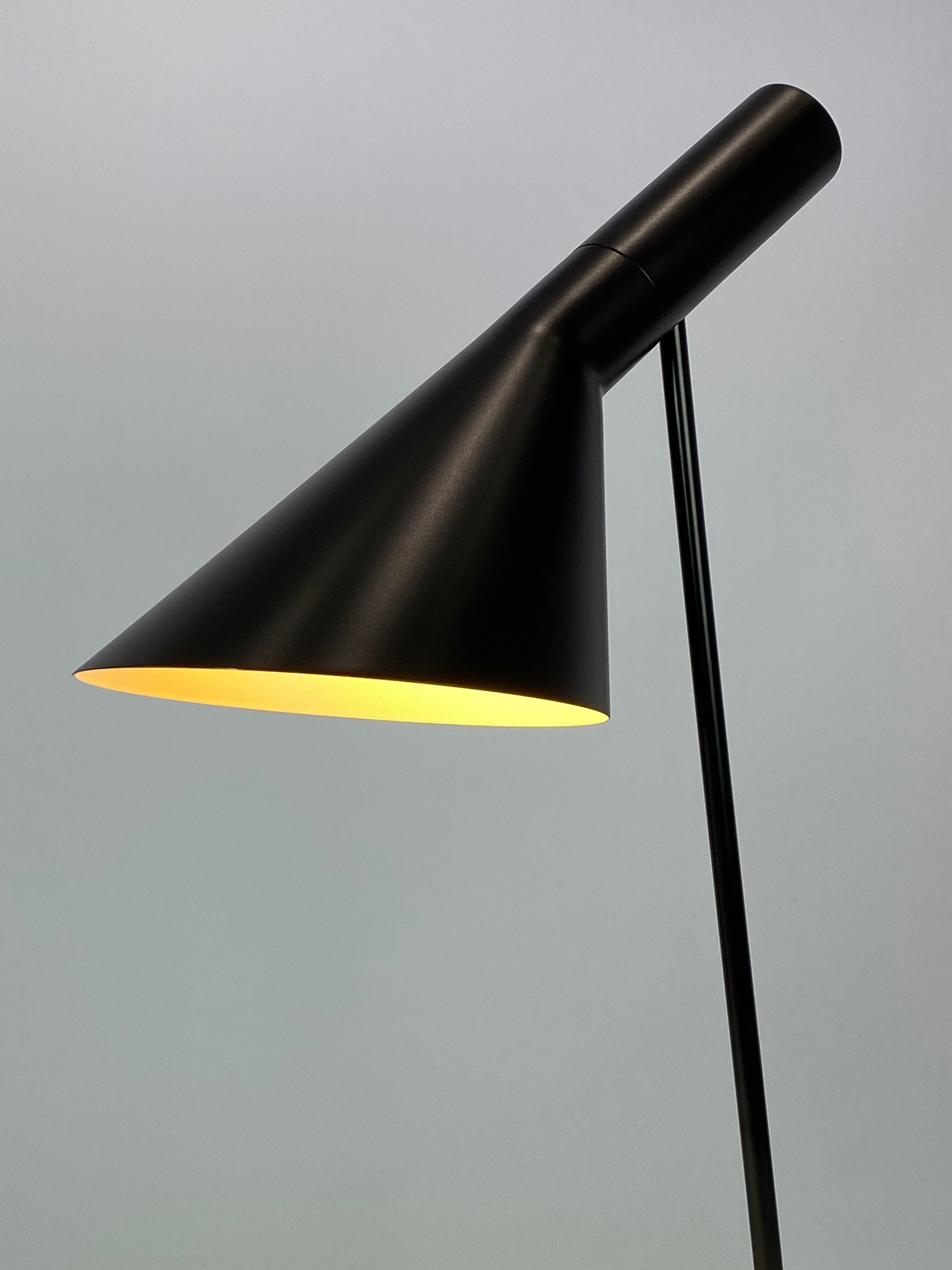 Black table lamp designed by Arne Jacobsen and manufactured by Louis Poulsen