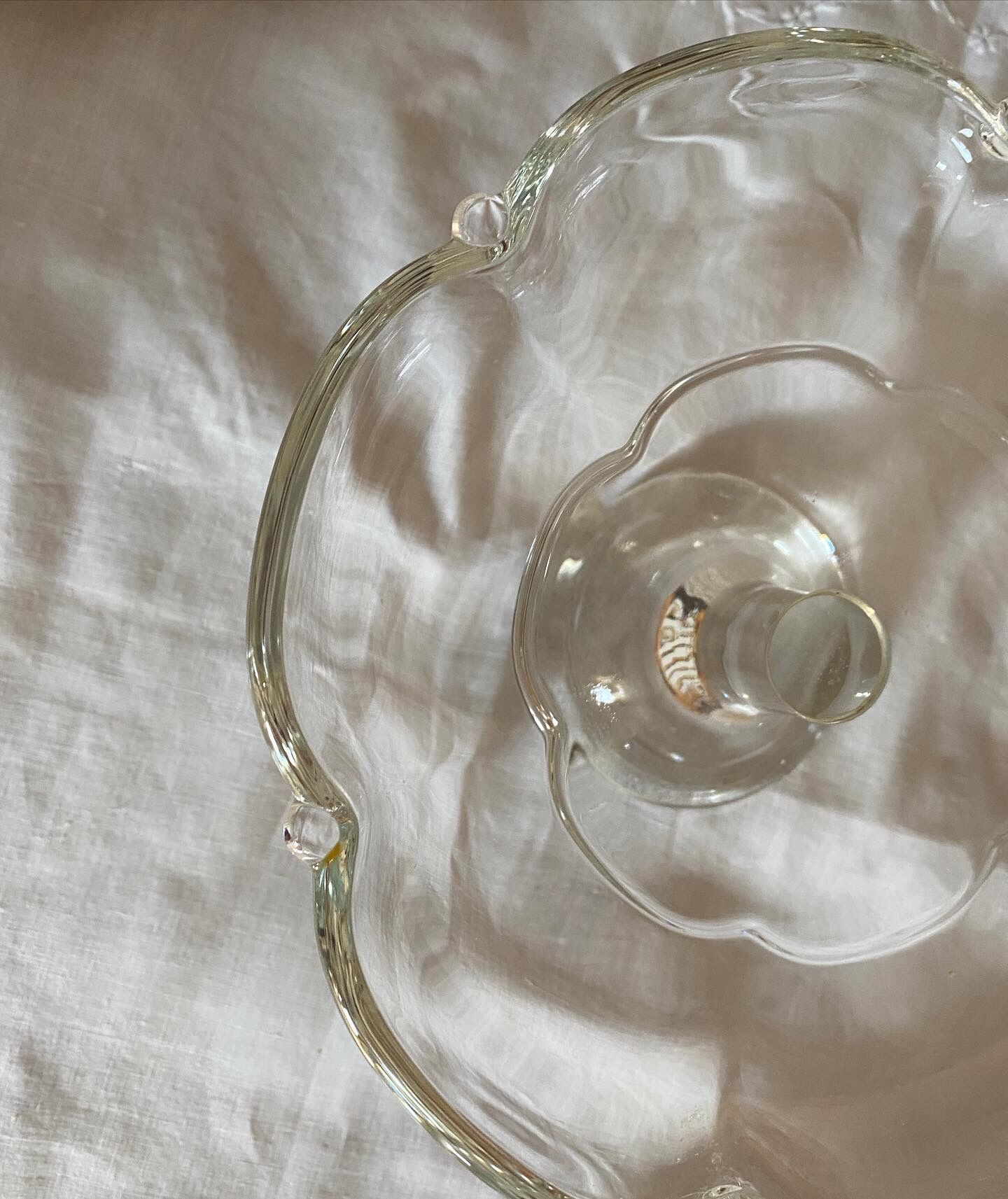 Standing molded glass cup depicting a flower