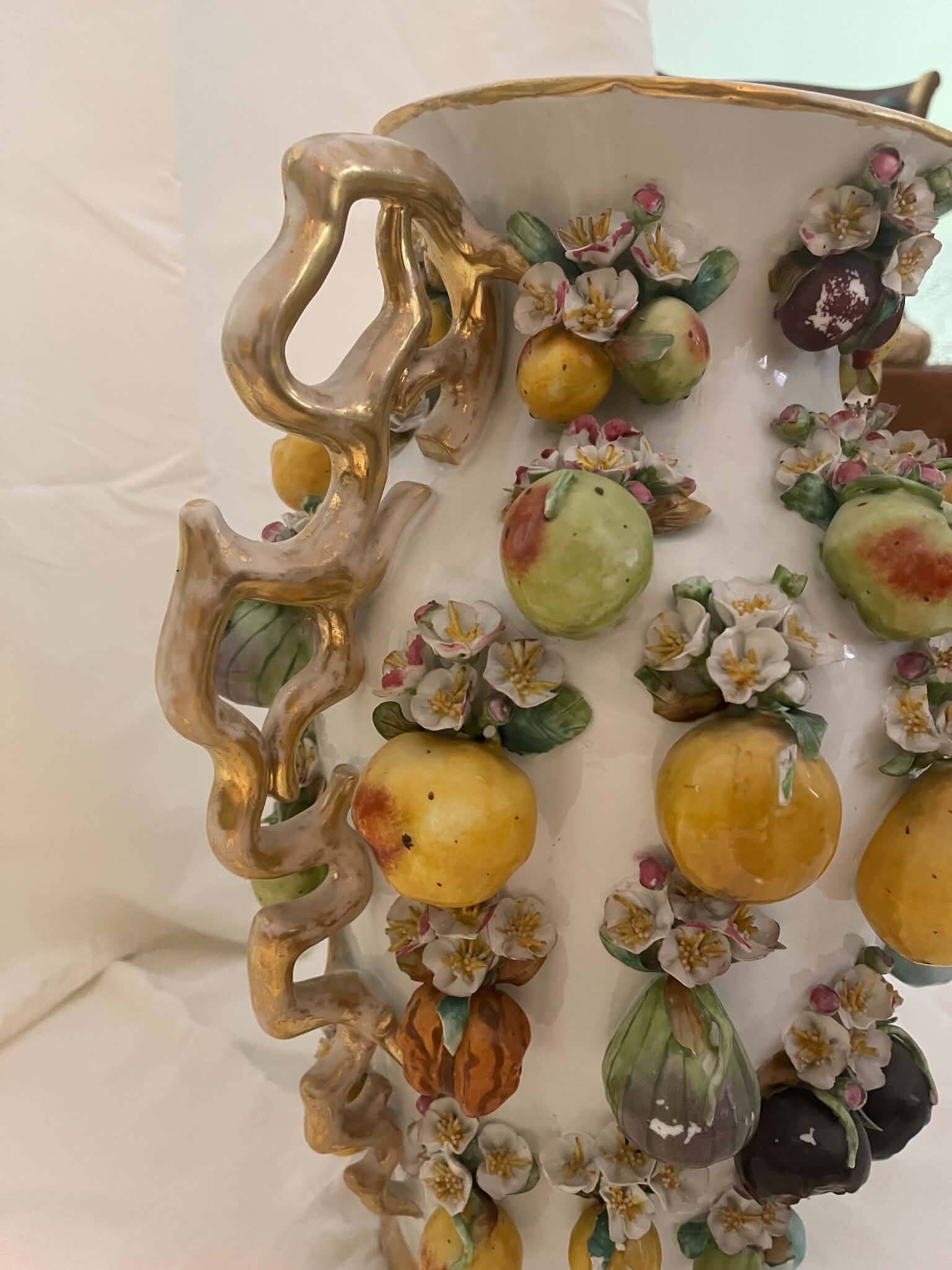 Large antique vase with relief decorations of coloured fruits.