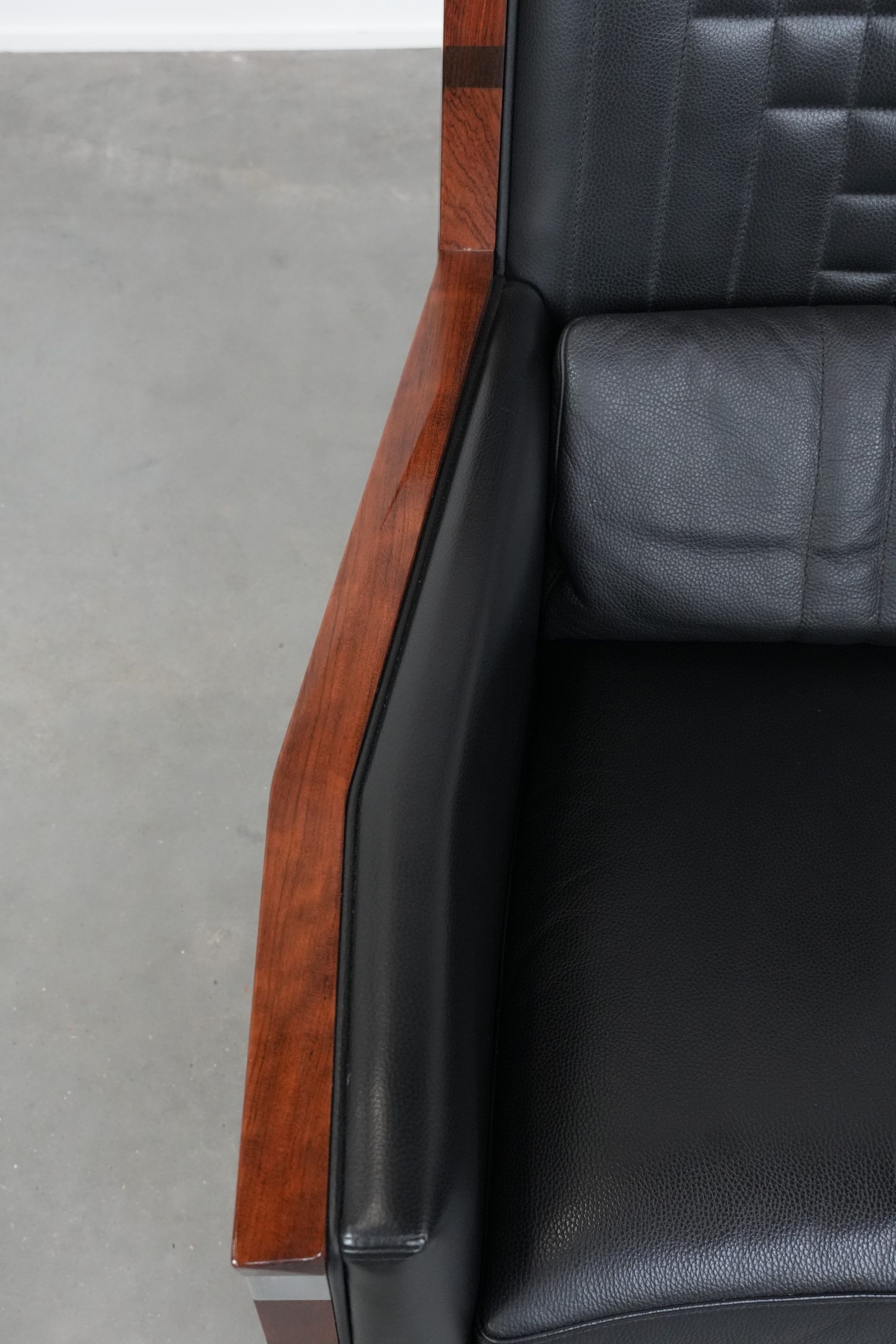 Art Deco design armchair with black leather with decorative stitching