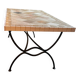 Beige ceramic coffee table with black metal legs.