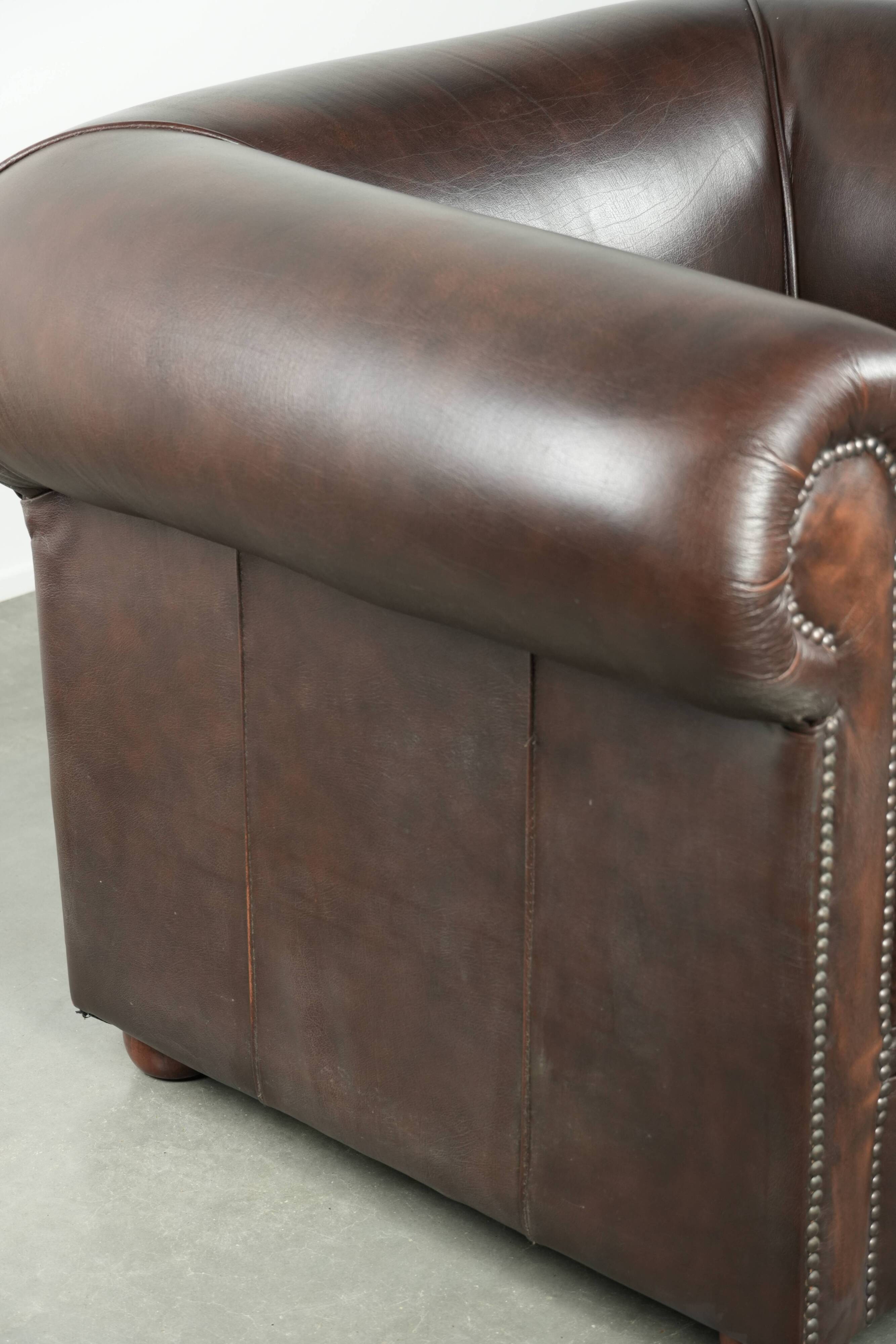 Set of a smooth chesterfield sofa and armchair with a timeless English look