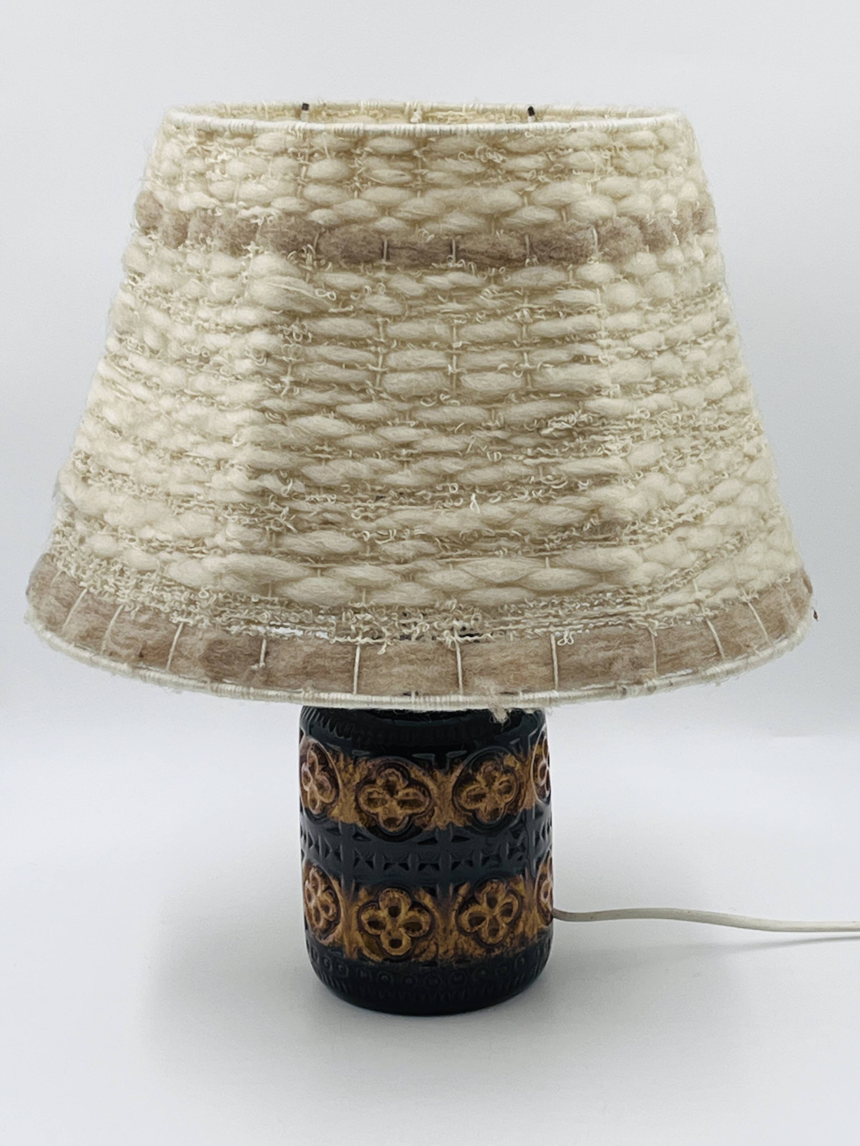 Vintage ceramic lamp with relief and wool shade.