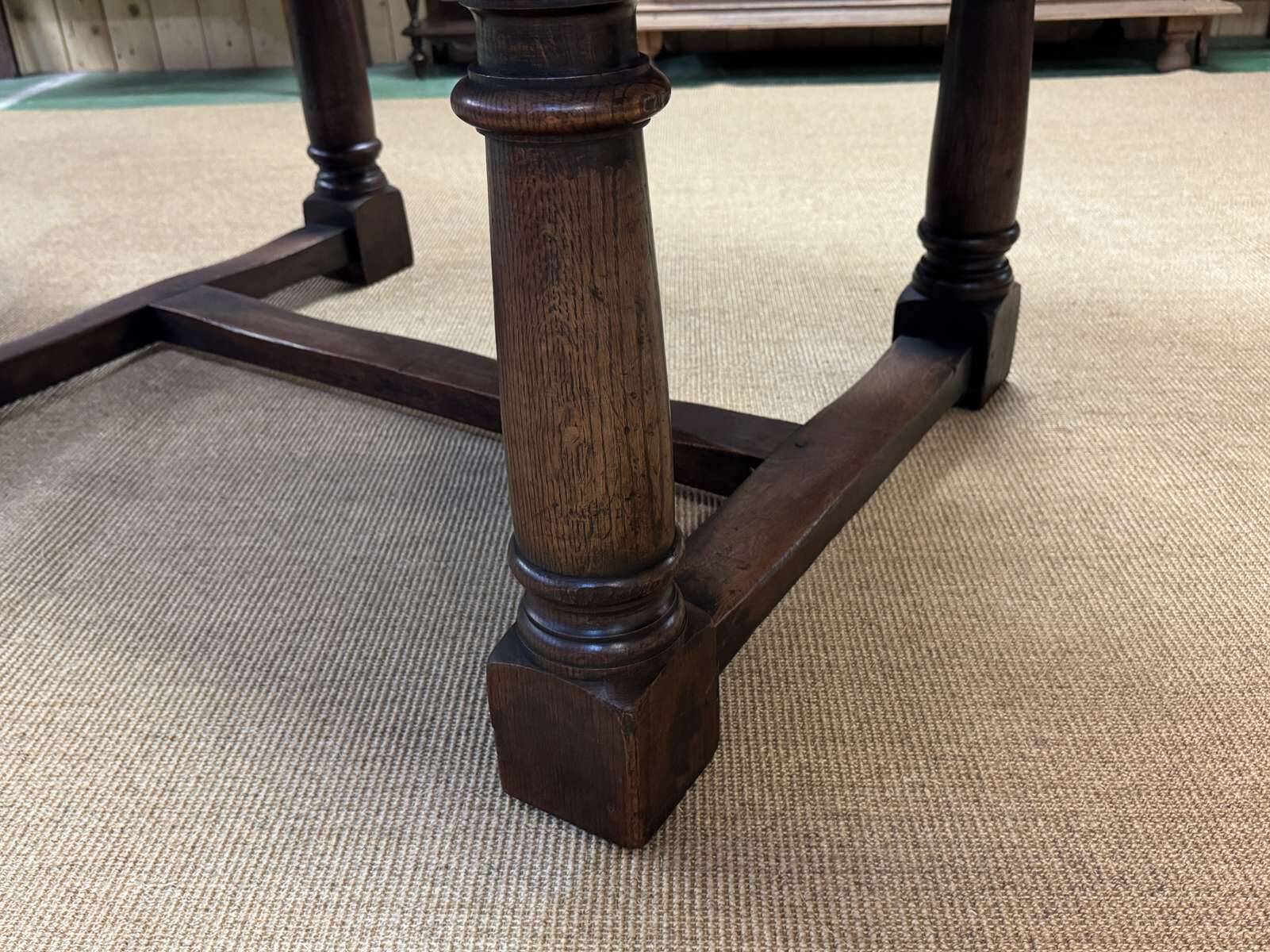 English monastery table with extensions from the late 19th century in elm and oak.