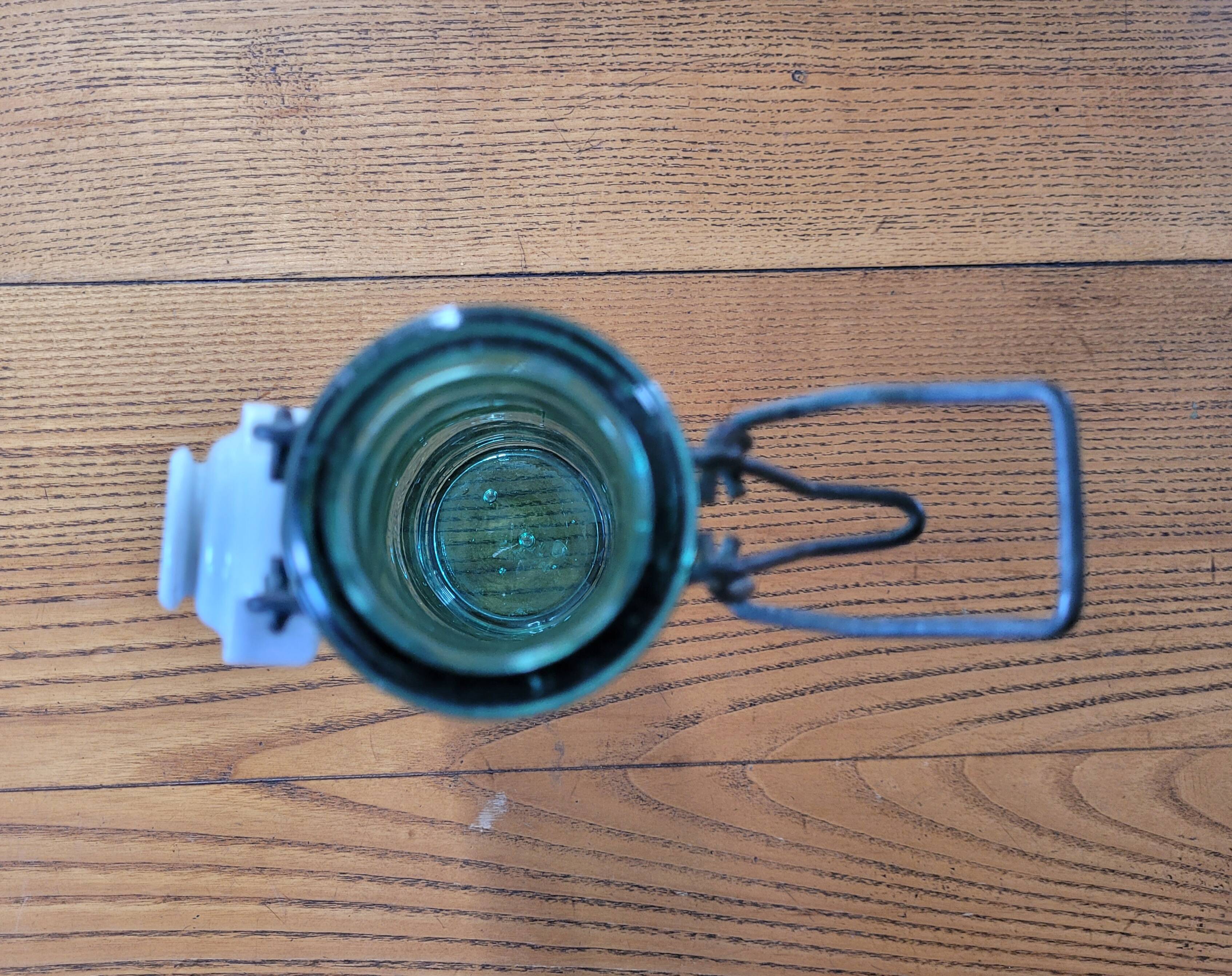 Vintage glass bottle l'Idéale with porcelain stopper