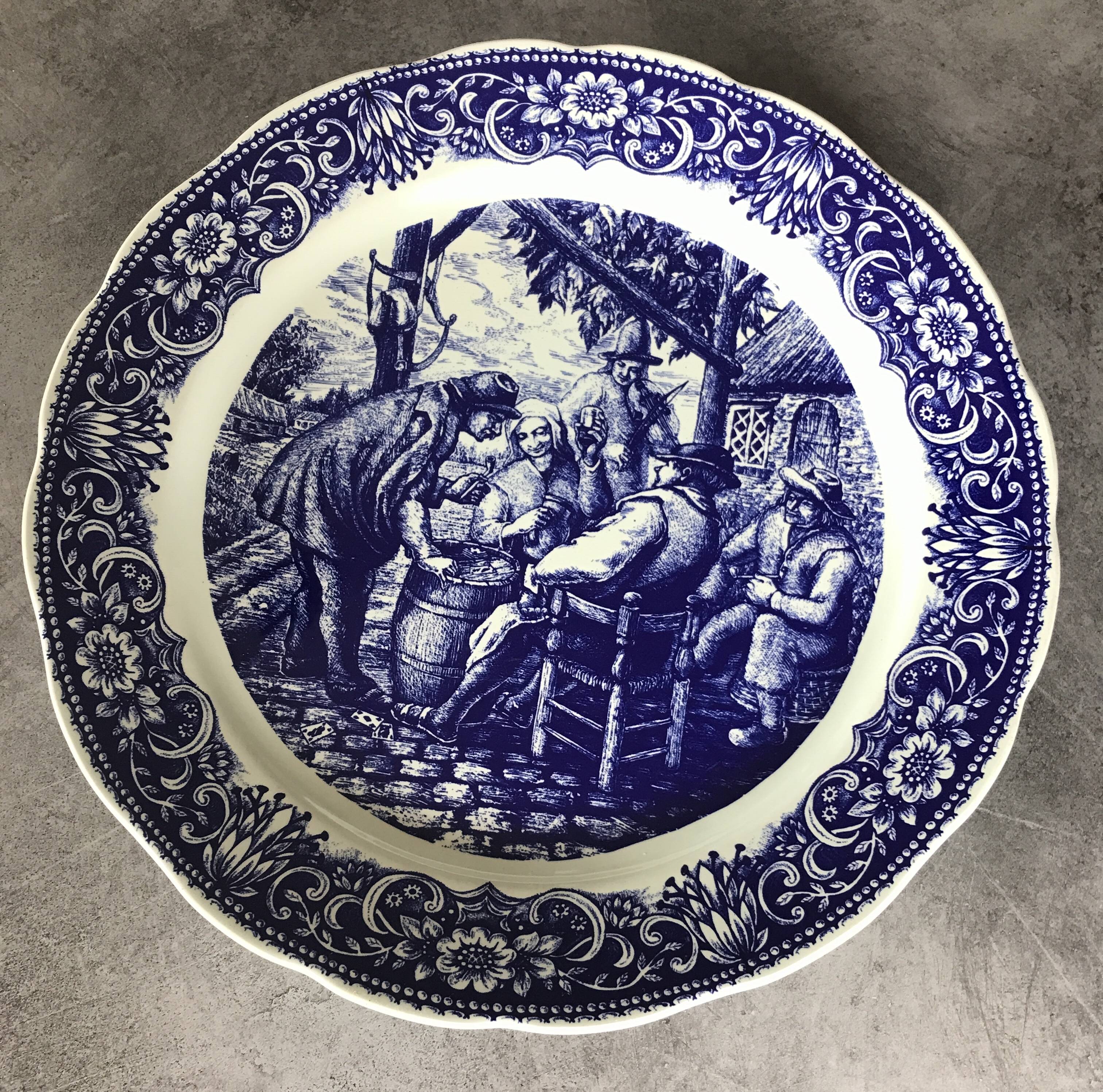 Blue enamelled earthenware wall dish with peasant scene decor Boch La Louvière