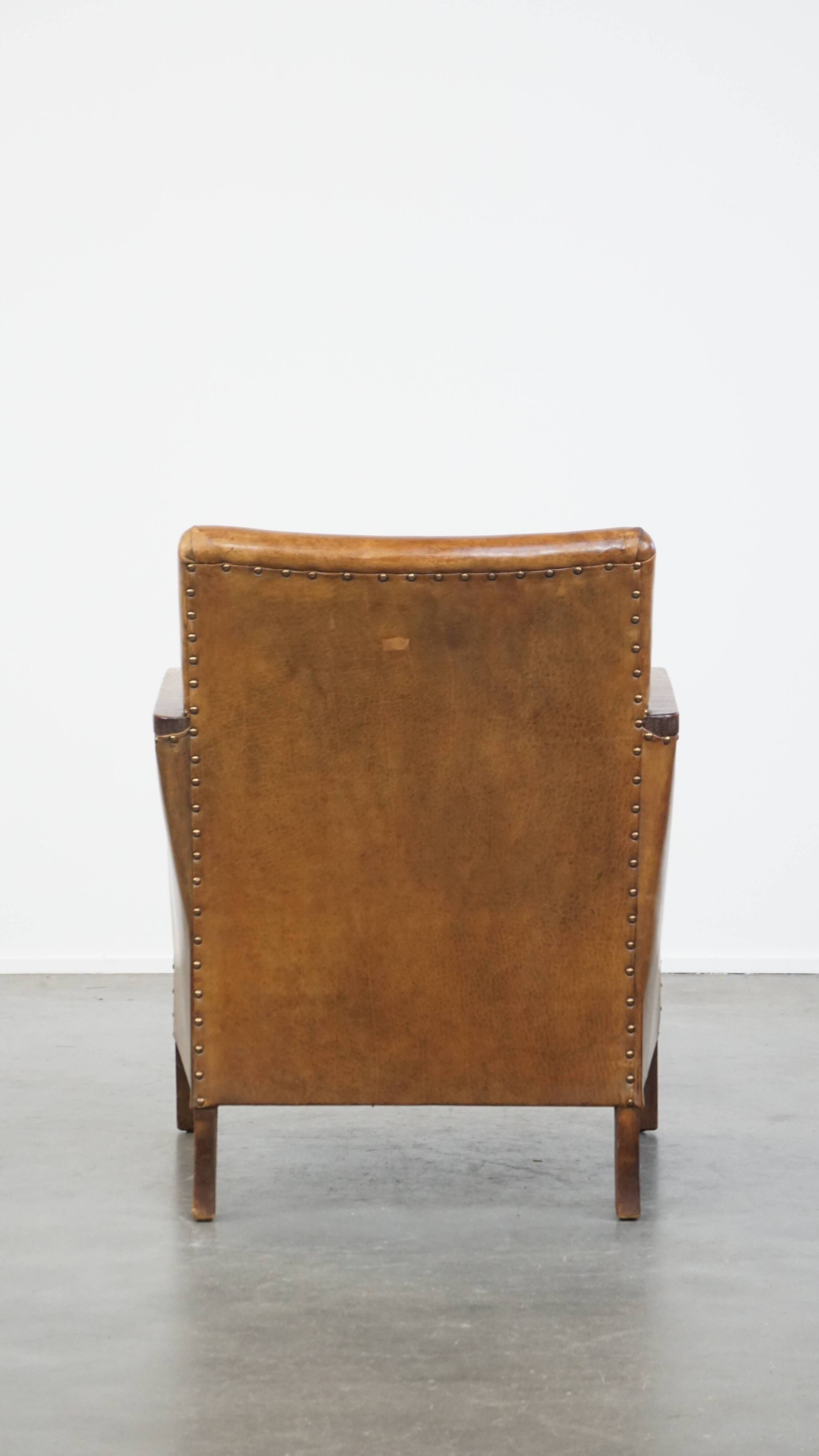 Cognac-colored sheepskin and wooden Art Deco design armchair