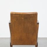 Cognac-colored sheepskin and wooden Art Deco design armchair