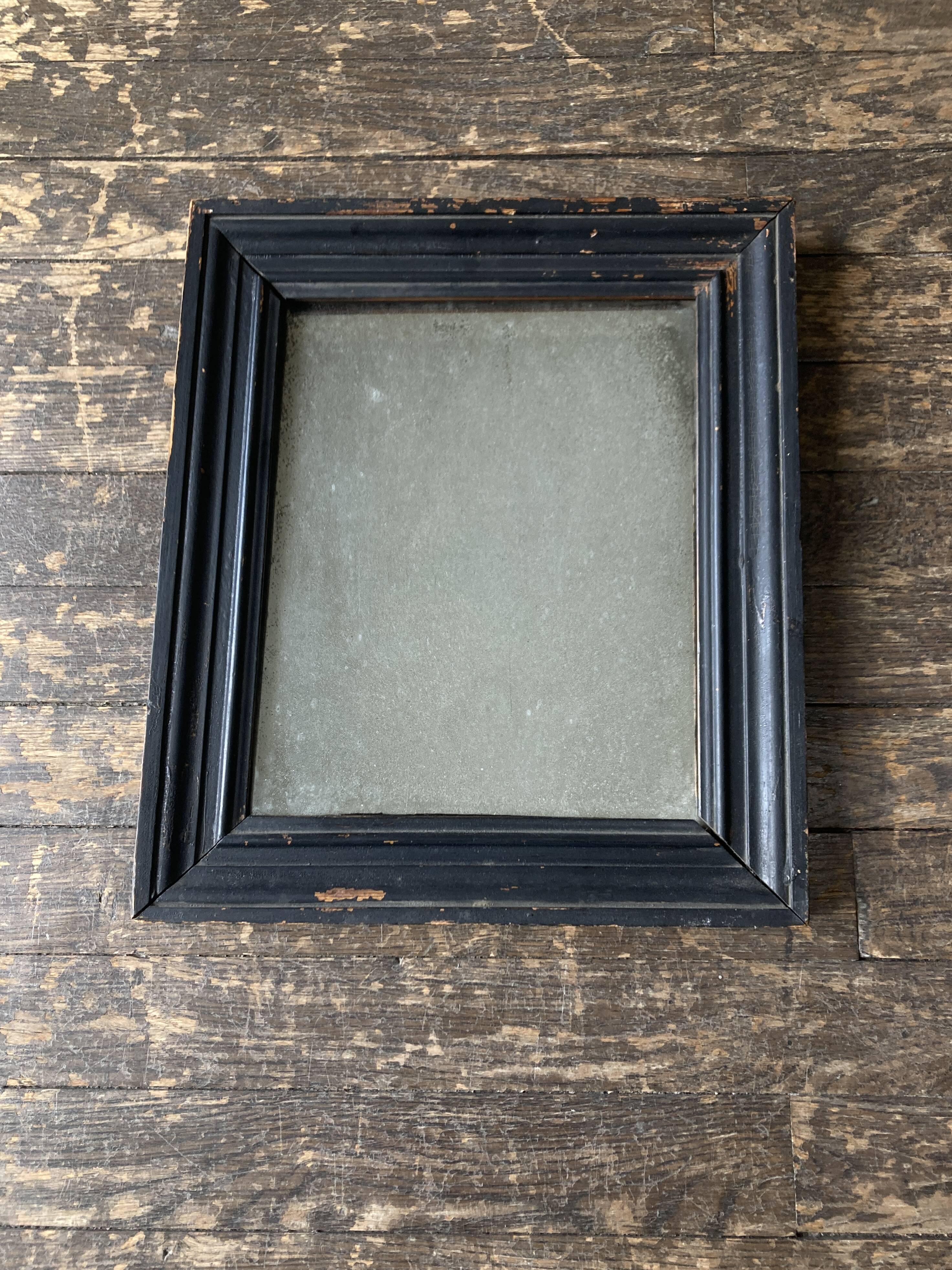 19th century blackened mirror with pitted glass 34cm x 40cm