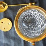Glass and gold metal ice bucket with its gold metal spoon.