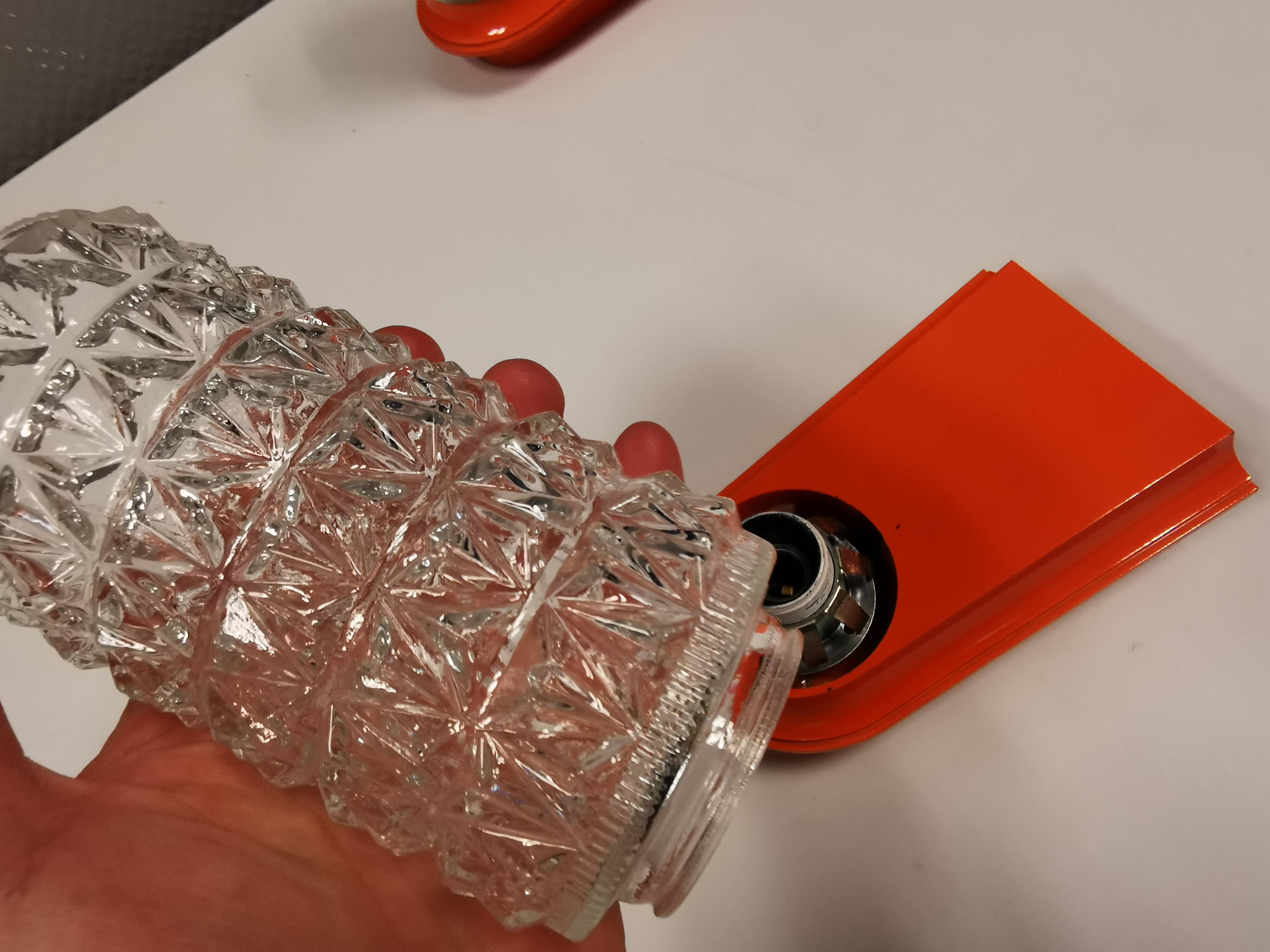 Bathroom lamps in a nice orange colour with a crystal glass shade and a base of hard thin plastic