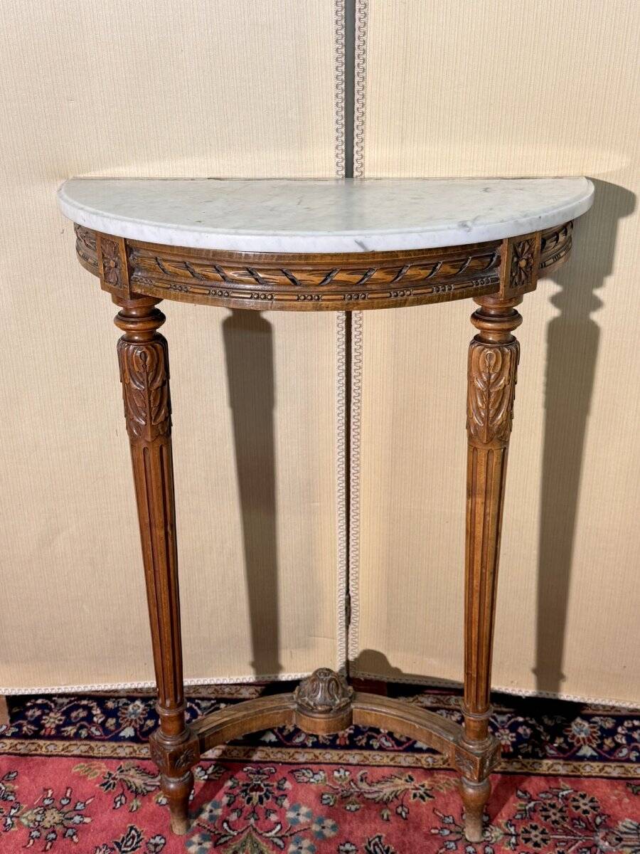Half-moon console in Louis XVI style made of carved wood.