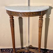 Half-moon console in Louis XVI style made of carved wood.