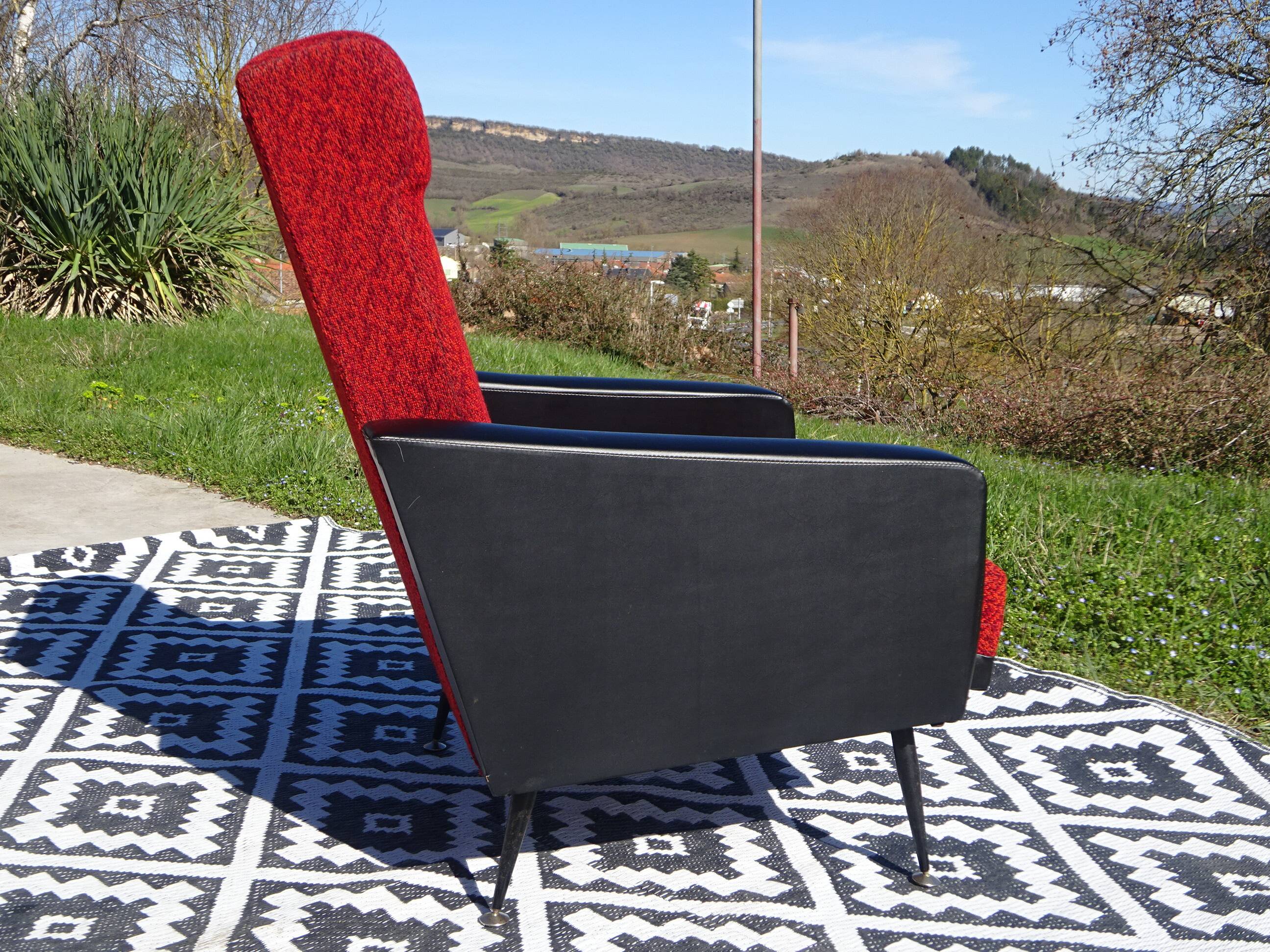 Vintage armchairs in red and black faux leather, the pair.