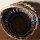 Vintage wooden basket with round handle, blue and black weaving.