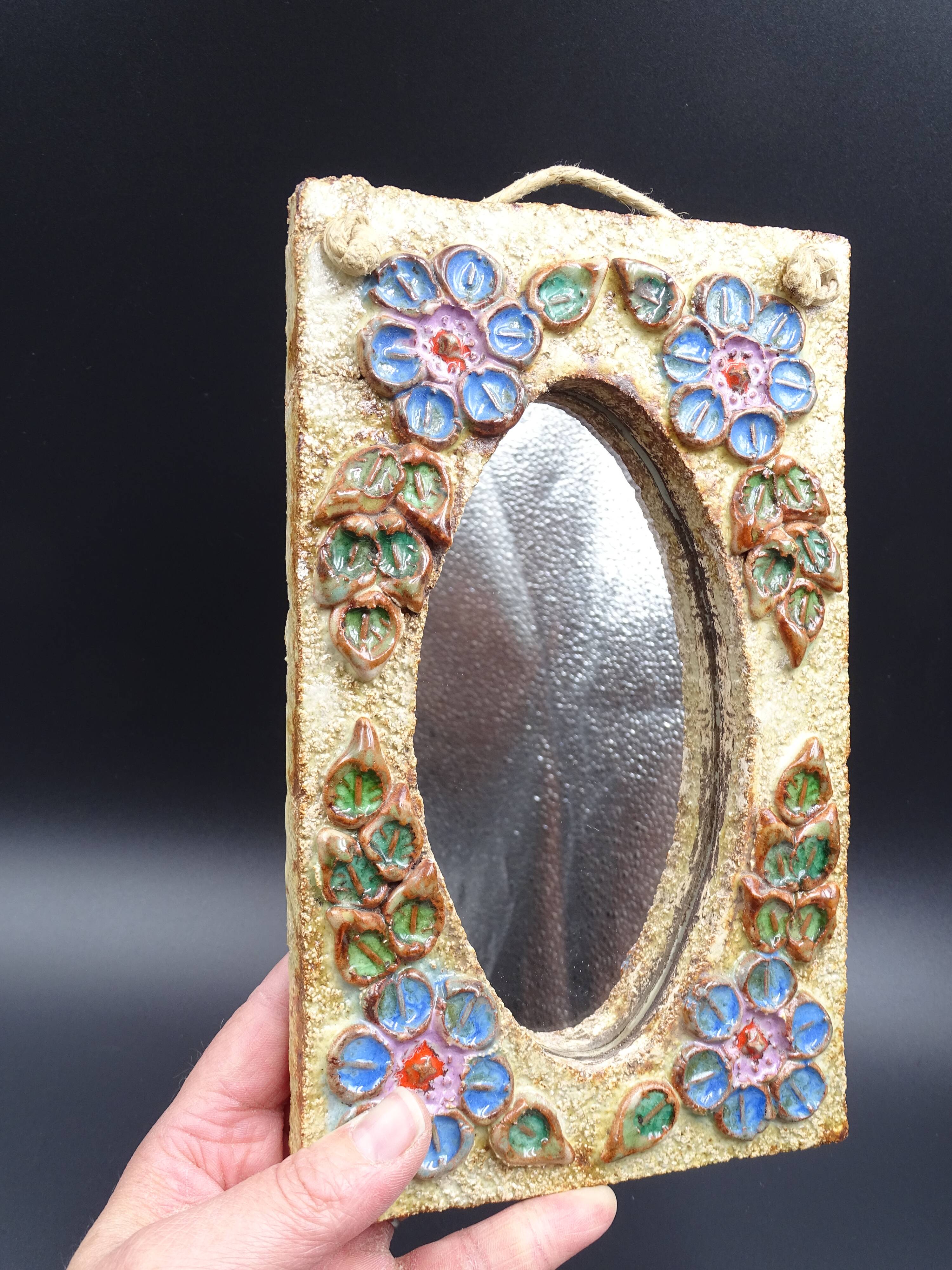 Flower-decorated sandstone mirror, circa 1970