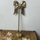 Solid brass bow and ribbon wall candle holder