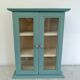 Green and beige 2-door wall display case