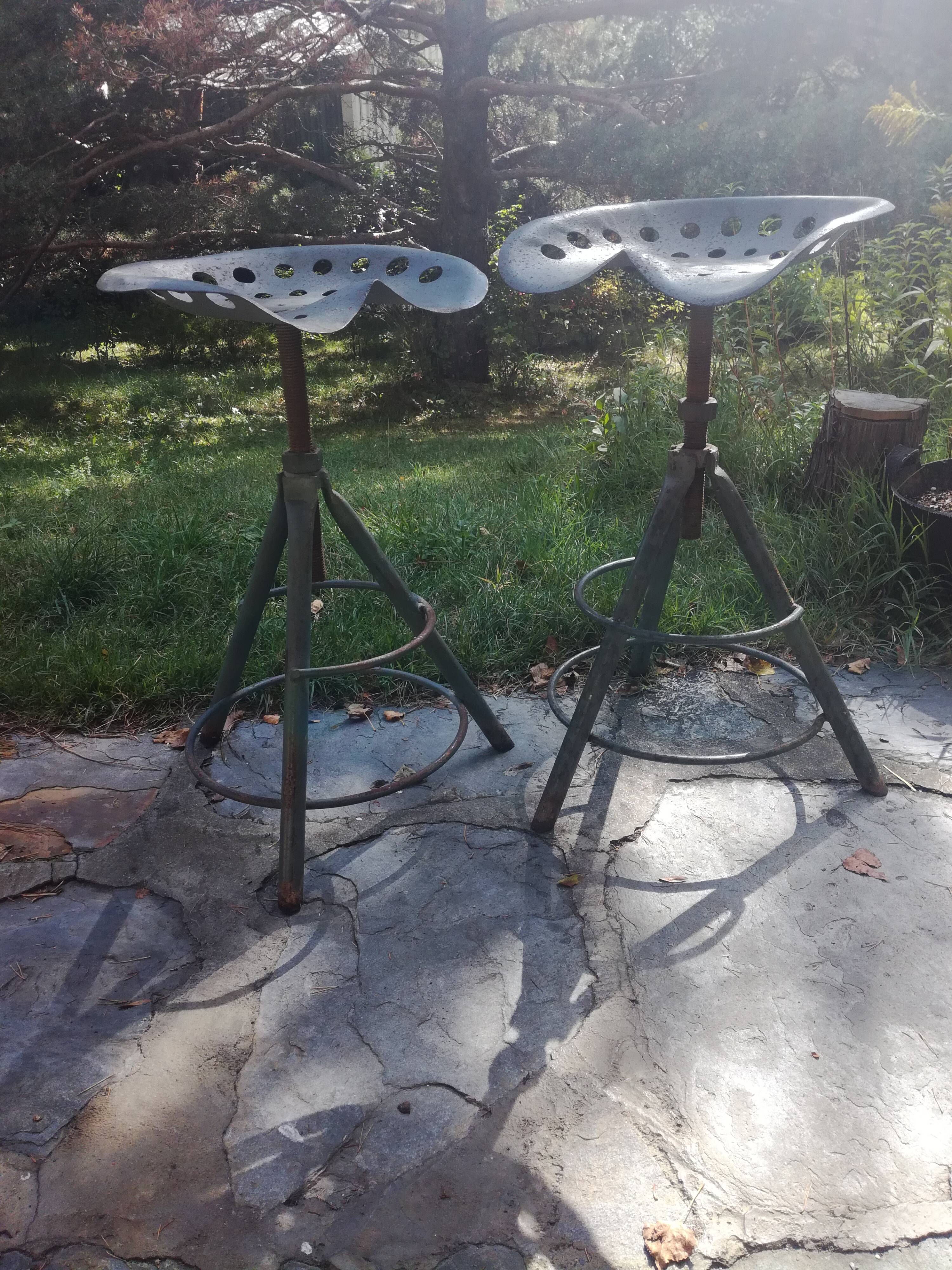 Two tractor-style industrial stools