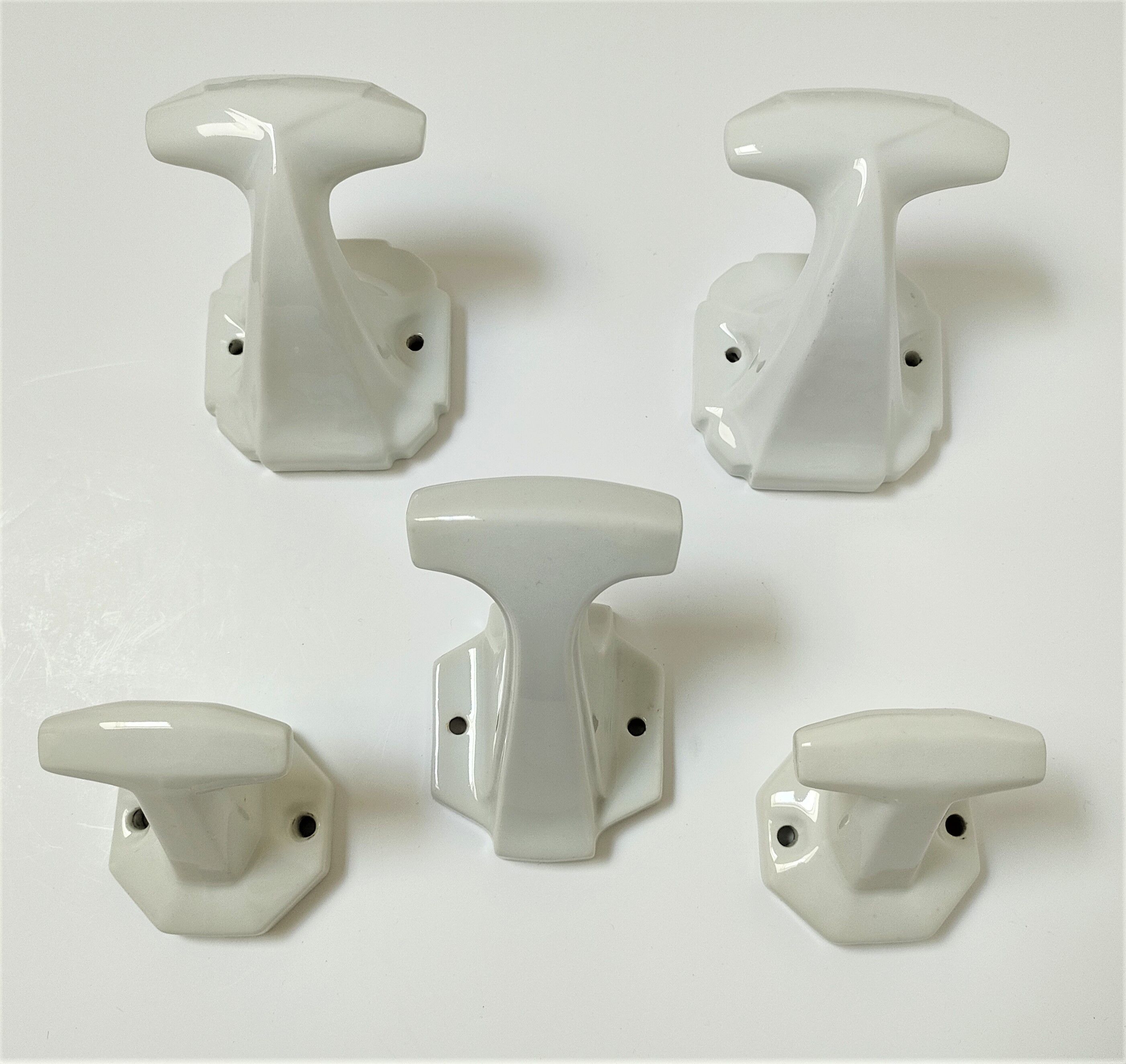 Five art deco white porcelain hooks