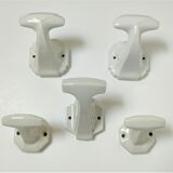 Five art deco white porcelain hooks