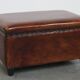 Cognac-colored sheepskin stool with decorative studs