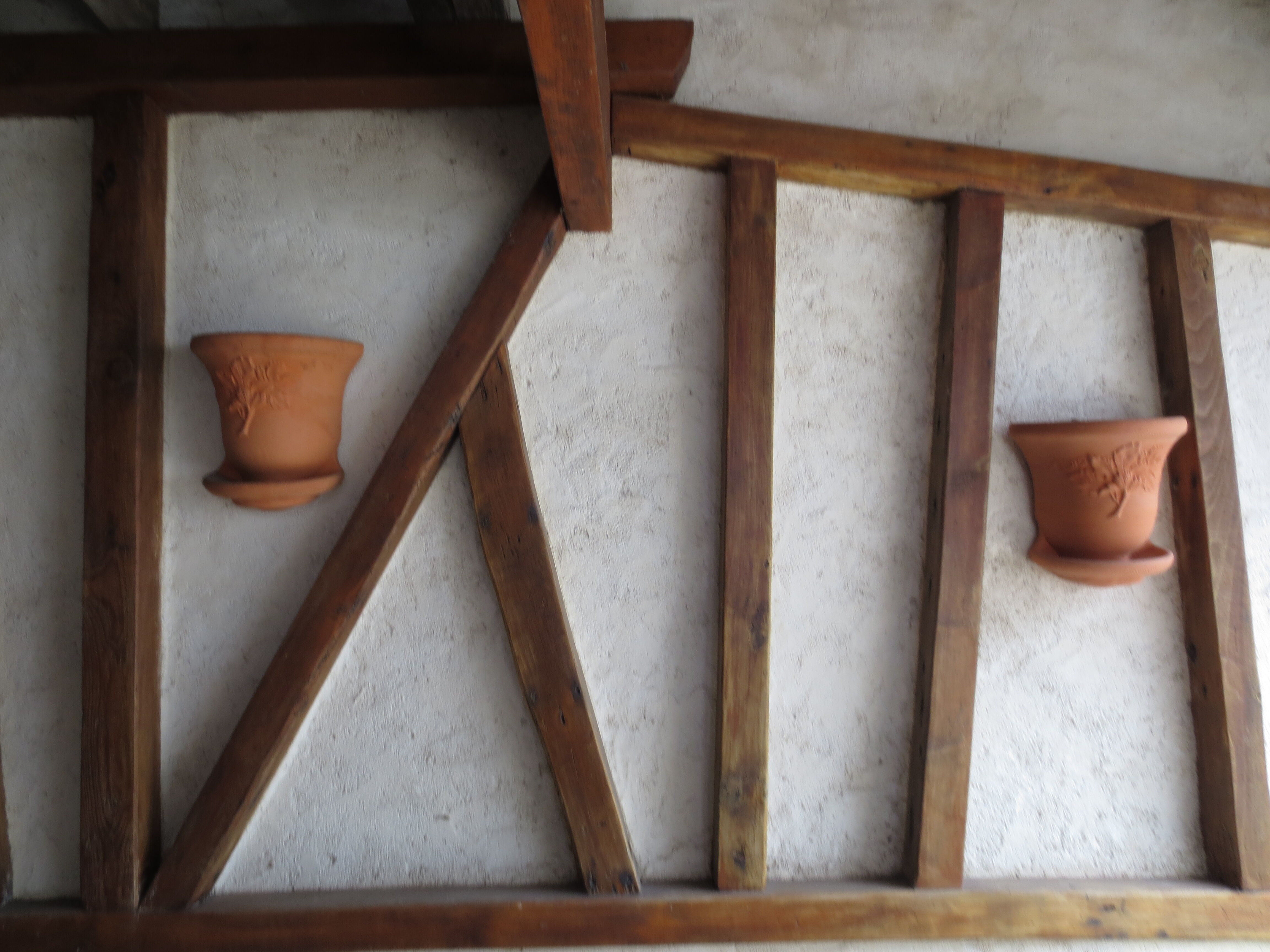 Pair of decorated terracotta wall flower pots