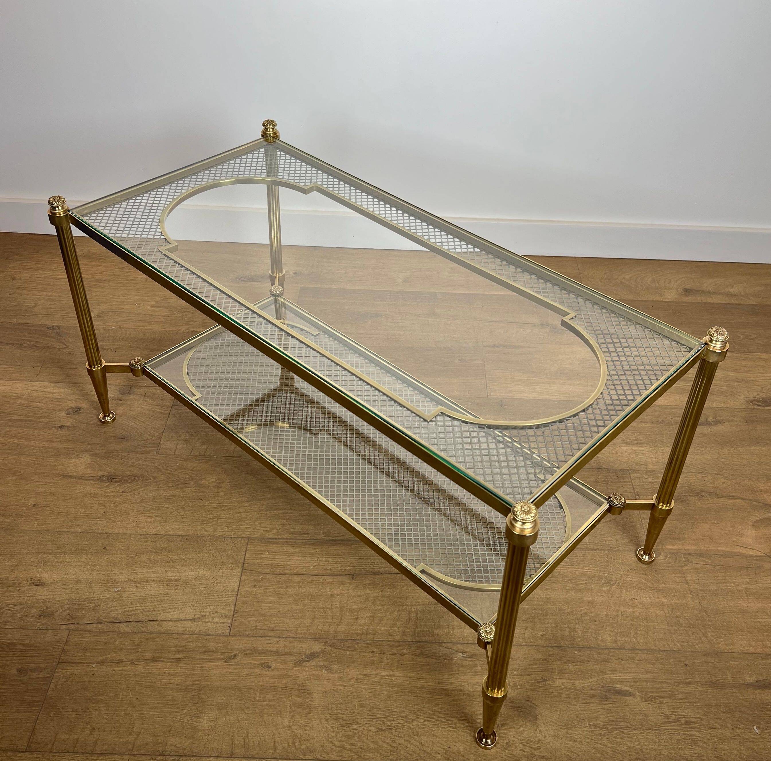 Rare bronze, brass, and steel mesh coffee table with a double glass top resting on a brass mesh. French work by Jansen