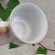 Coffee cup with floral design in porcelain