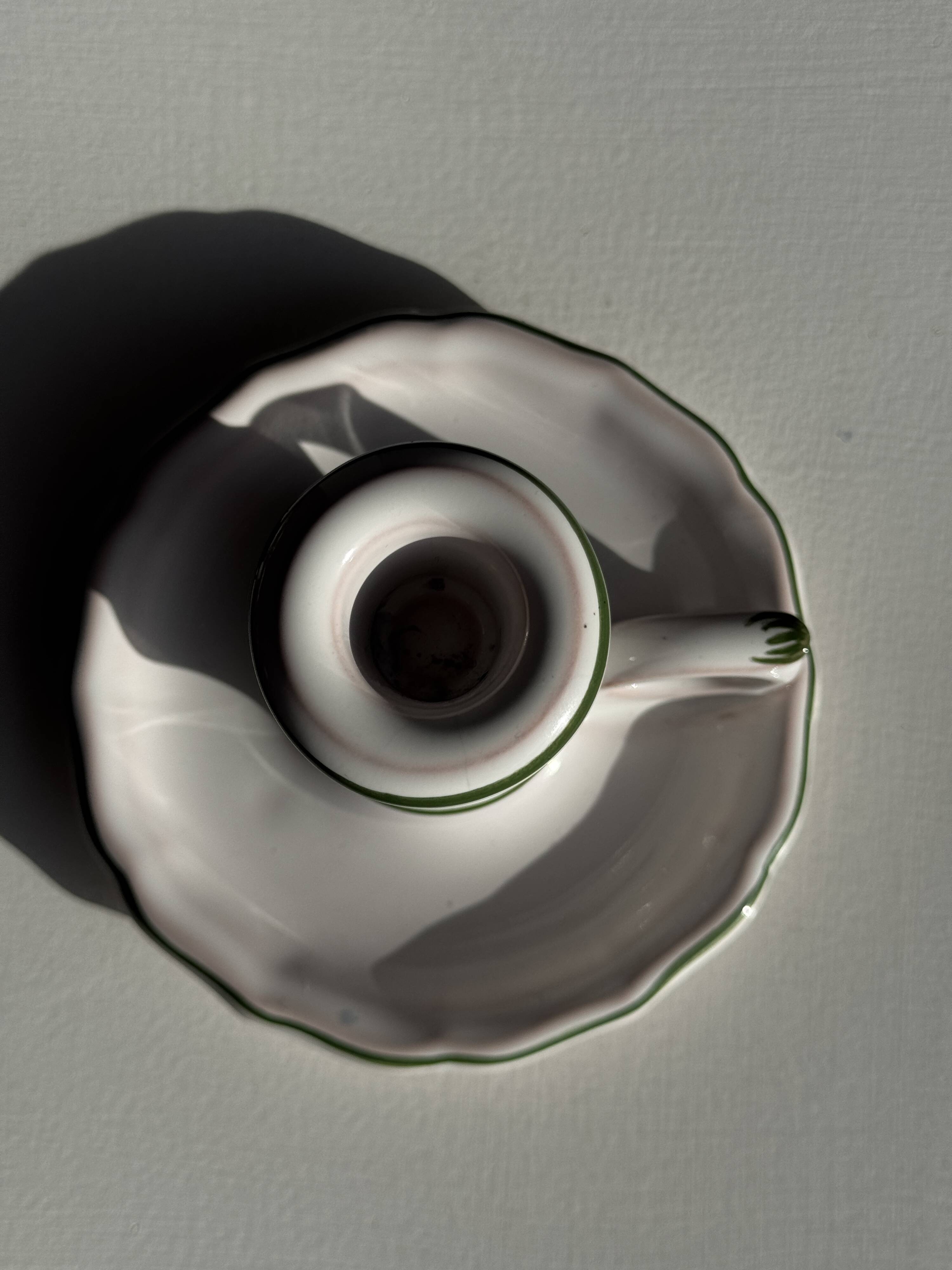 Small vintage hand-held candlestick in earthenware with green trim and floral decoration H10.5