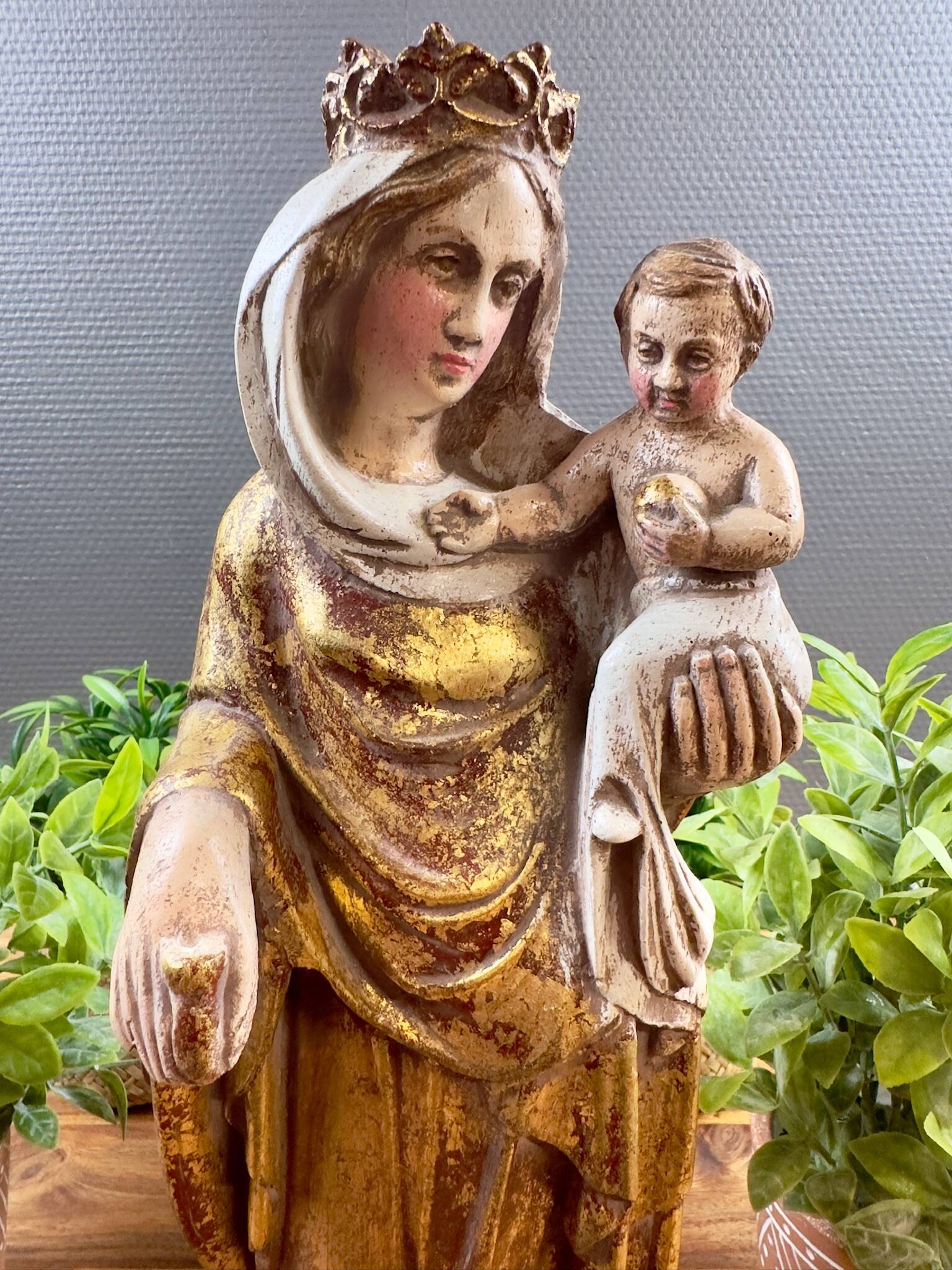 Statue of the Virgin holding the Child Jesus in polychrome terracotta.