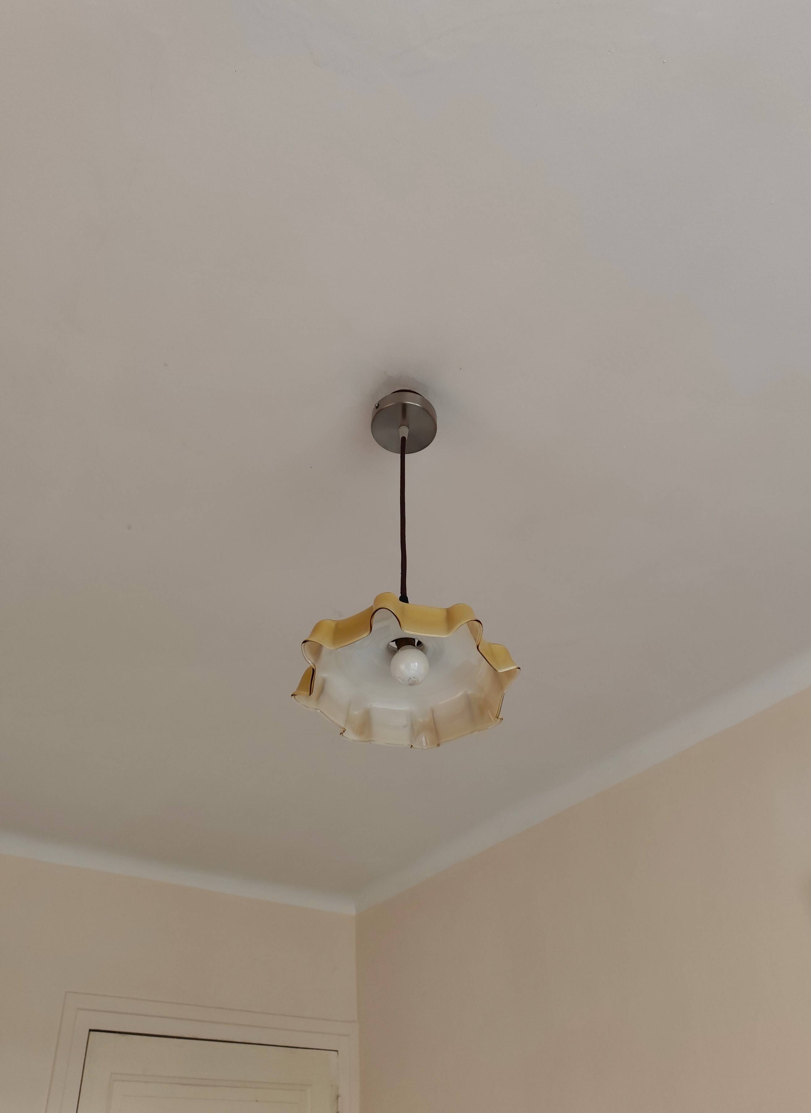 Electrified suspension with a frosted opaque glass disc shade.