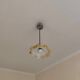 Electrified suspension with a frosted opaque glass disc shade.