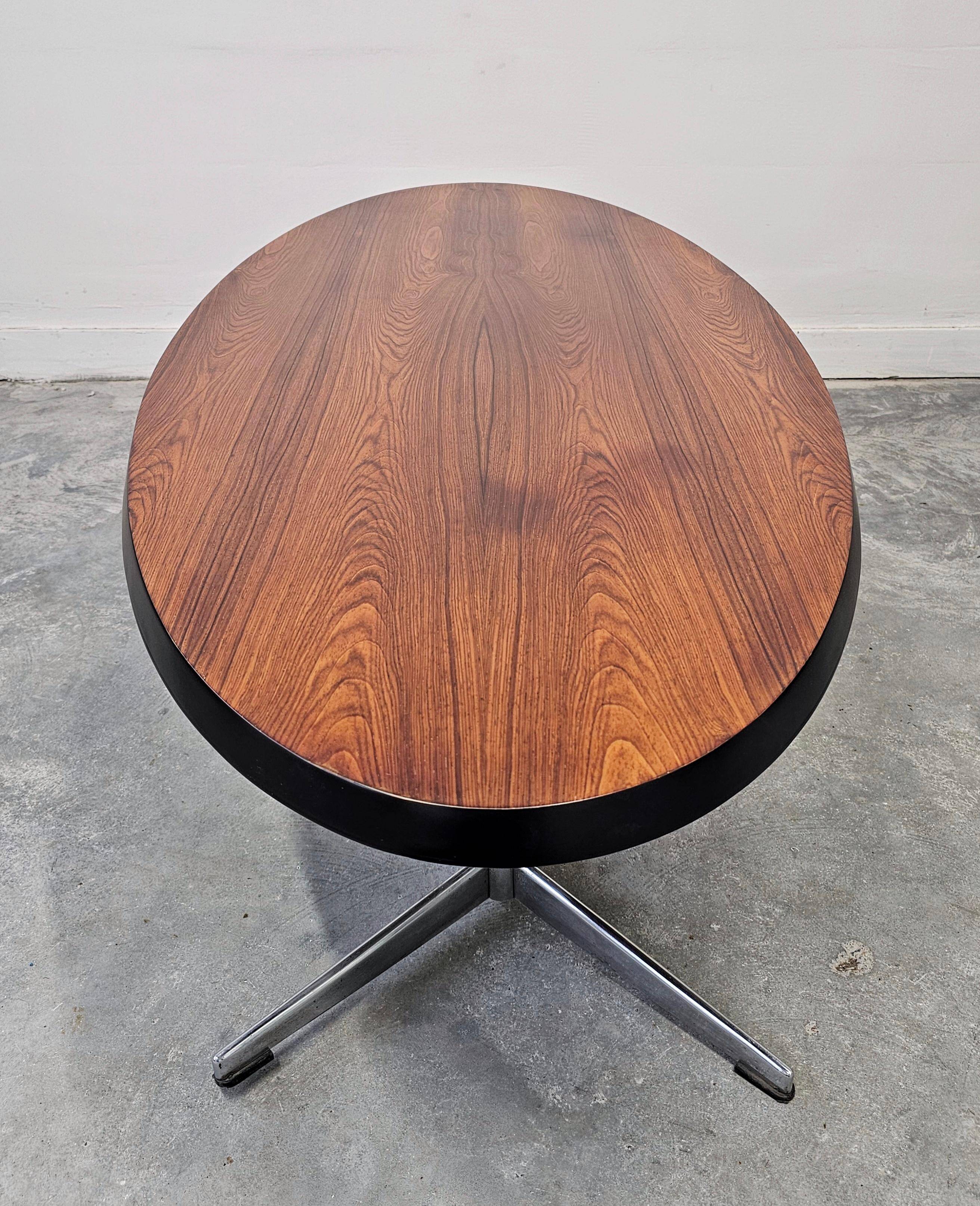 Danish Mid Century Modern oval coffee table with a teak top and chrome legs.