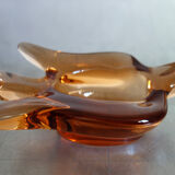 Old empty pocket/swallow ashtray in amber glass