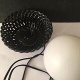 Table lamp with black porcelain support in the shape of a woven basket and opaque glass ball globe