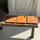 Small rectangular teak monoxyle cutting board with a circular handle.