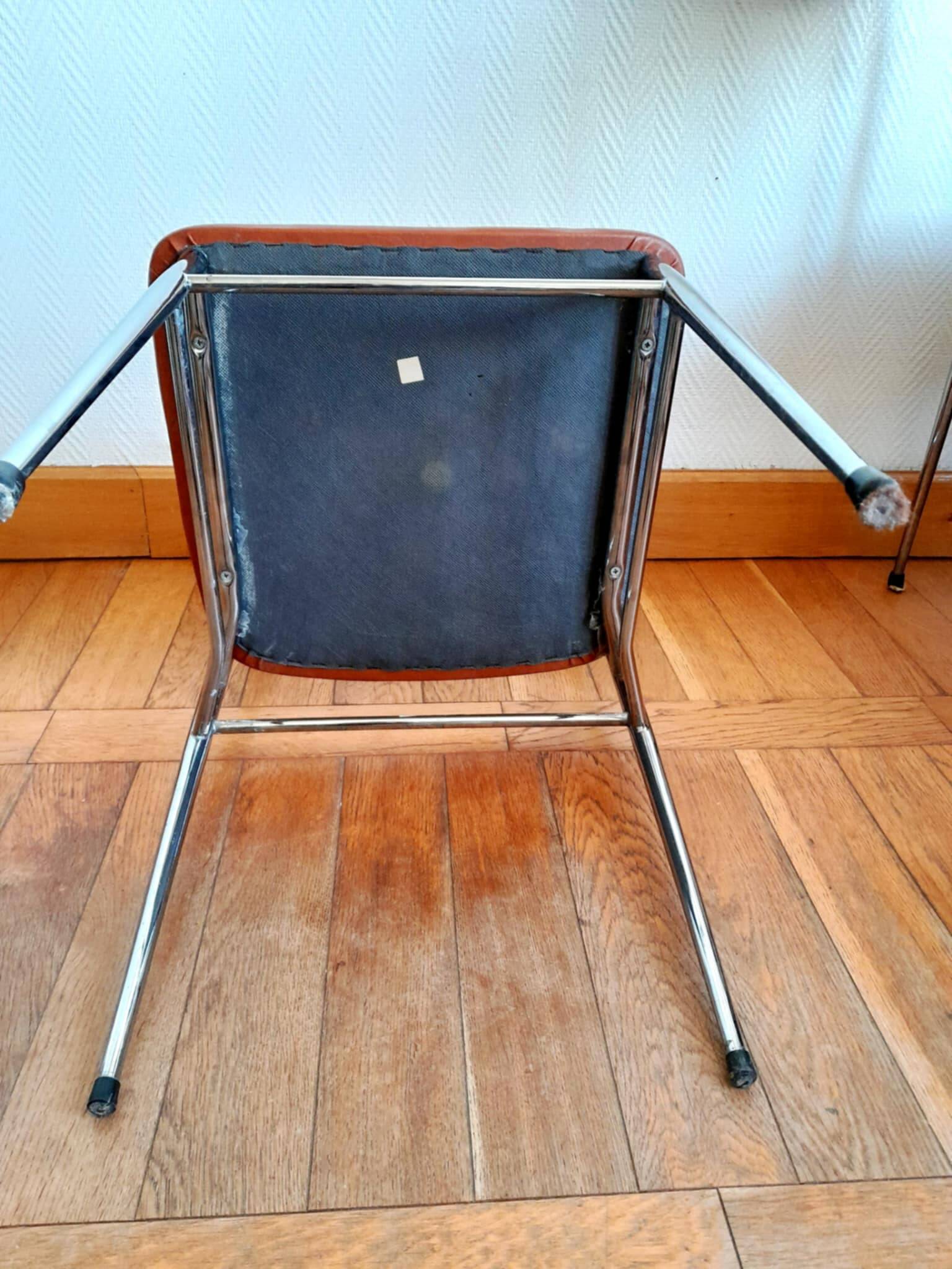 Three mid-century chairs in faux leather and chrome from the 1950s.