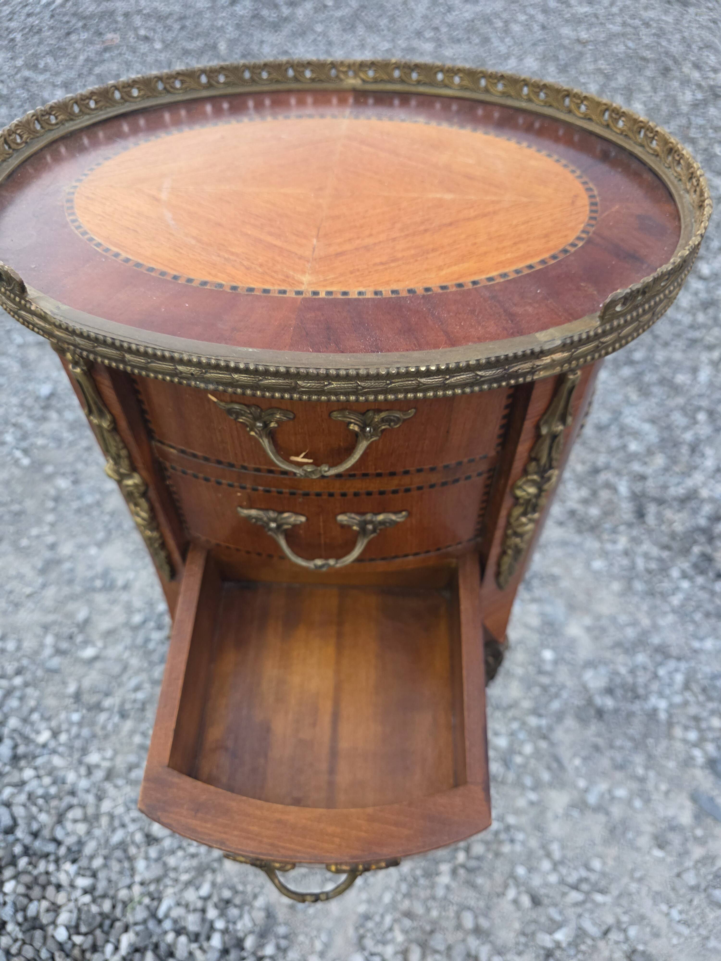 Oval bedside table in Louis XV style with marquetry.