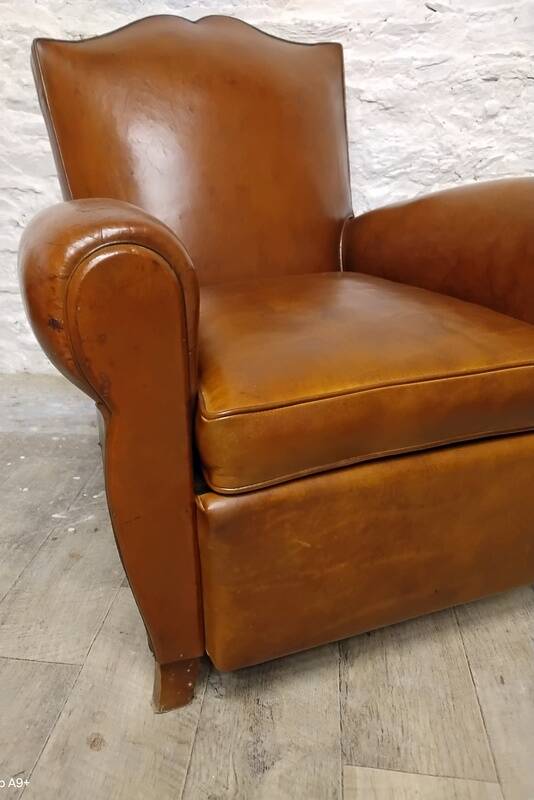 Antique club chair with mustache back