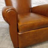 Antique club chair with mustache back