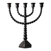 Candelabrum in the shape of a spool, skilfully forged in menorah style.