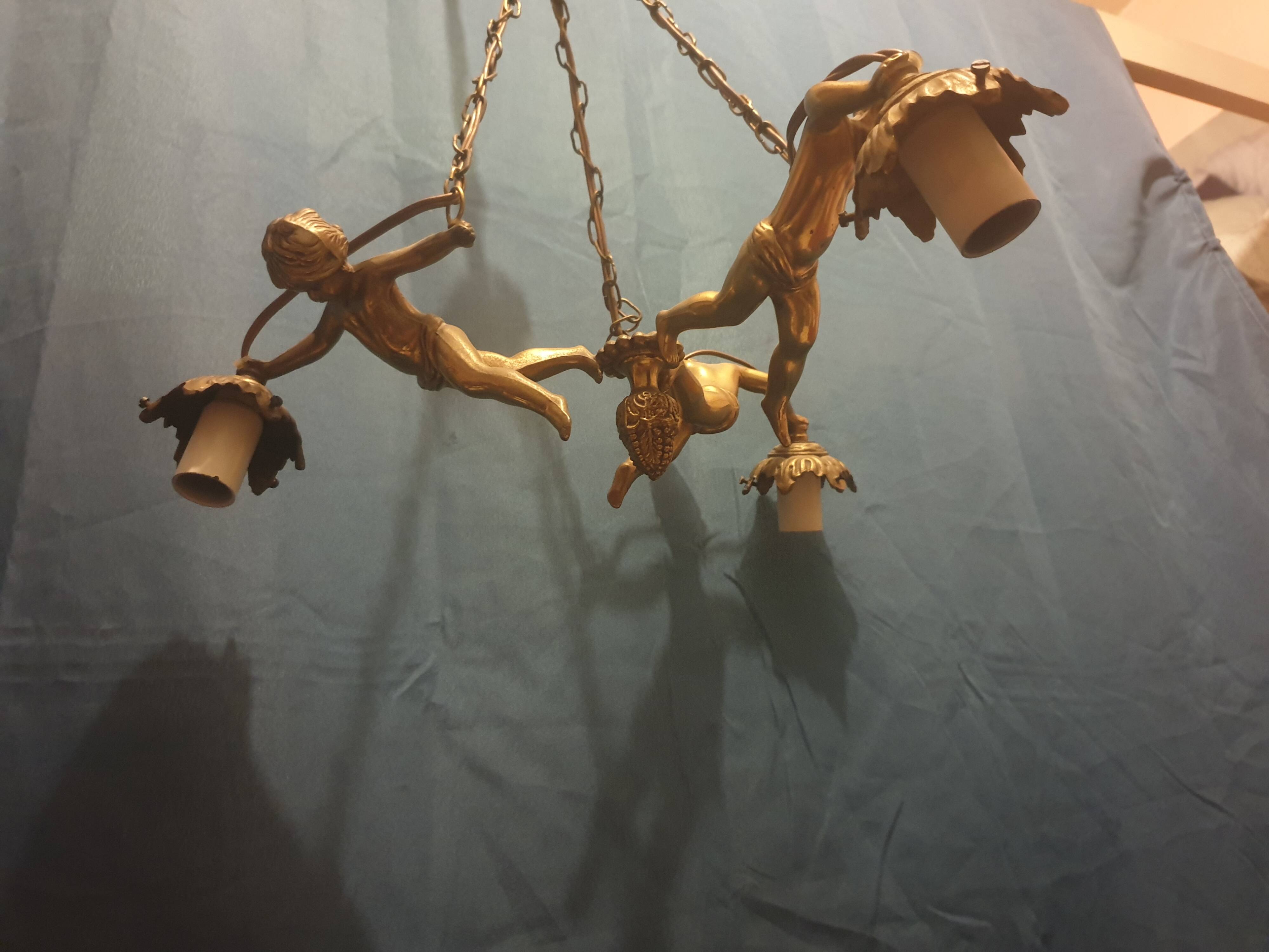 Antique chandelier decorated with cherubs and putti angels taken from the attic